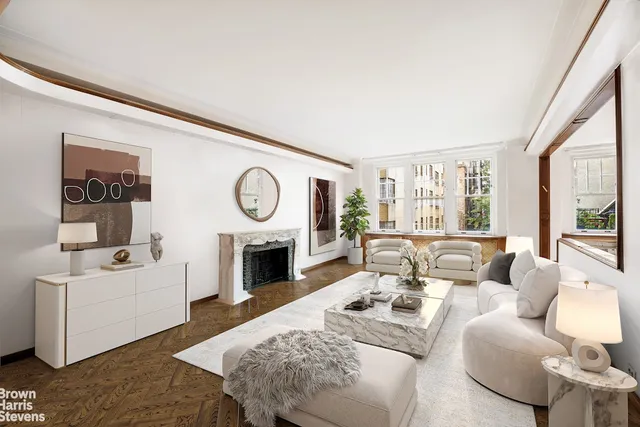 a living room with furniture a large window and a fireplace