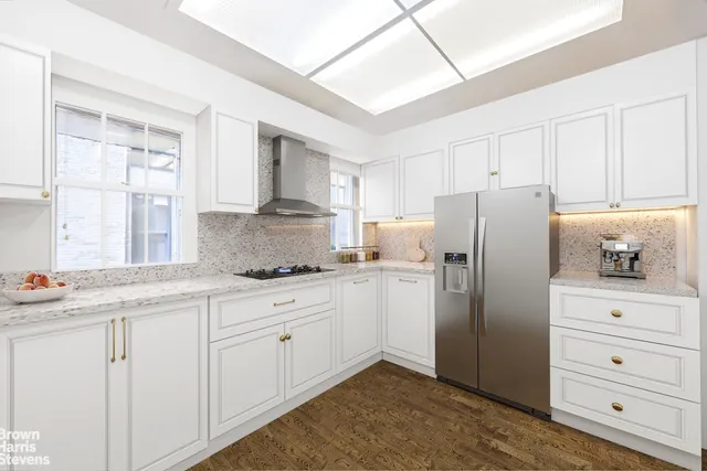 a dining room with furniture a chandelier and wooden floor