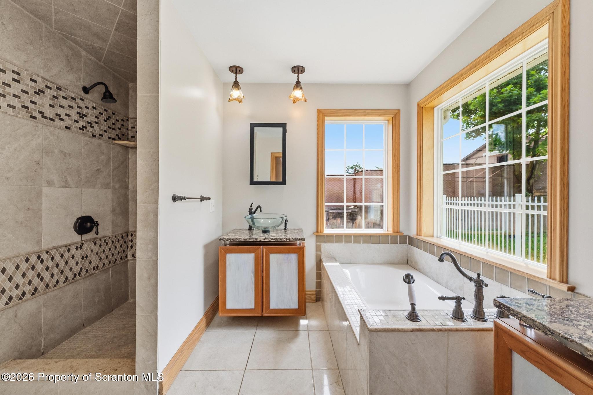 116 Forge Street Old Forge, PA 18518 - Photo 24 of 49 a bathroom with a tub sink and mirror