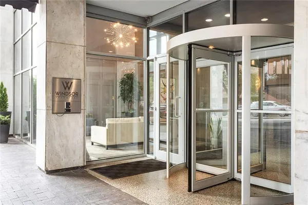 a bathroom with a glass door shower and sink