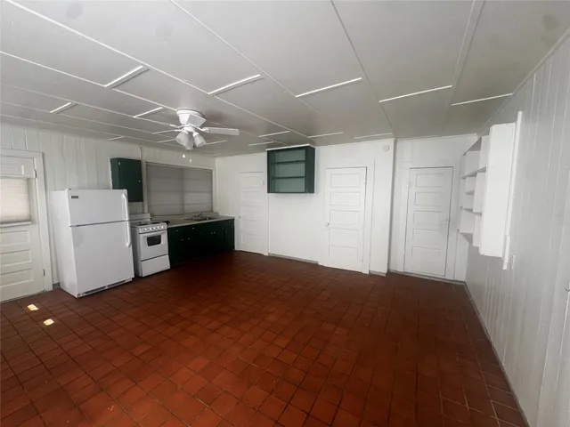 a view of a kitchen with a stove cabinets and a ceiling fan