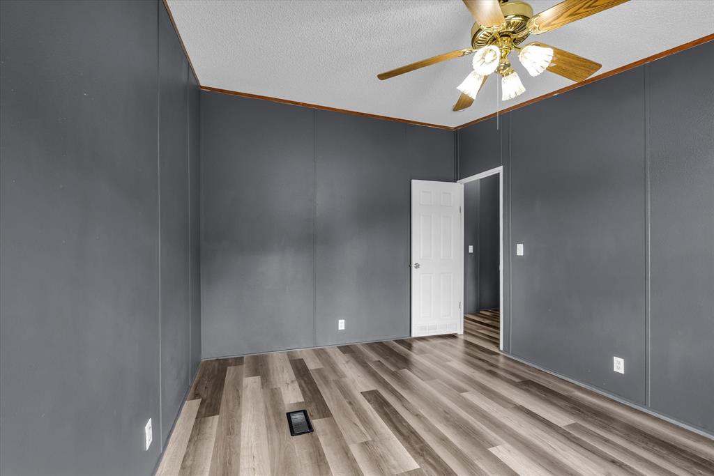3615 Spring Valley Road Lorena, TX 76655 - Photo 15 of 33 Spacious room featuring wood-finish flooring and a ceiling fan with integrated lighting