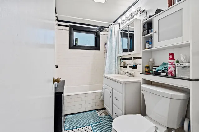 a bathroom with a sink a toilet and a mirror