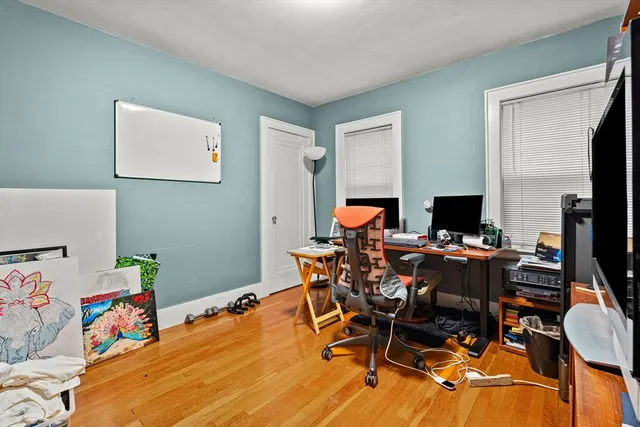 a view of a workspace with furniture and a flat screen tv