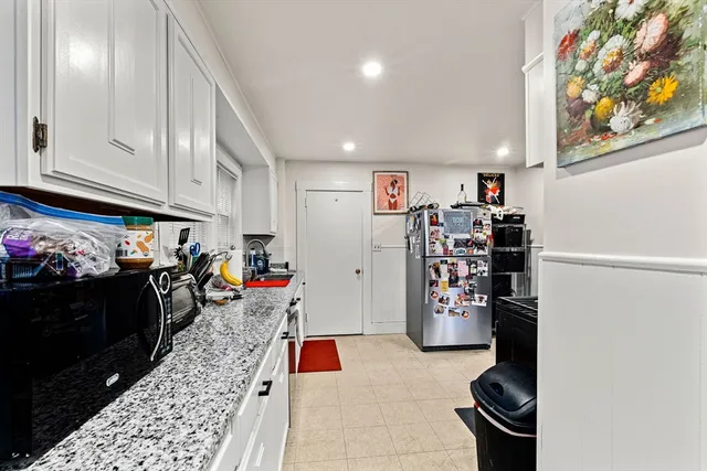 a living room with a couch and potted plant