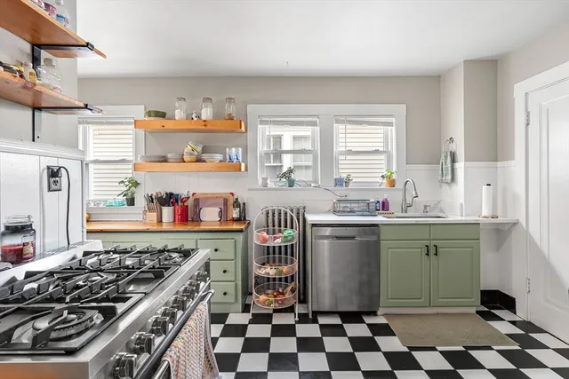 a kitchen with a stove a sink and a refrigerator