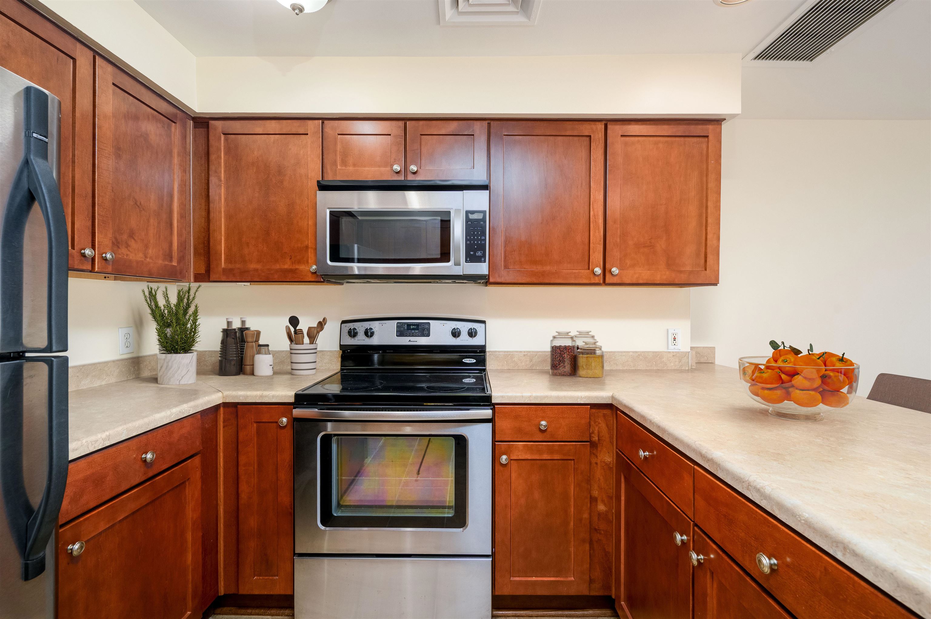 655 Riverside Drive, Unit 606A Memphis, TN 38103 - Photo 4 of 35 a kitchen with granite countertop a sink stove and microwave