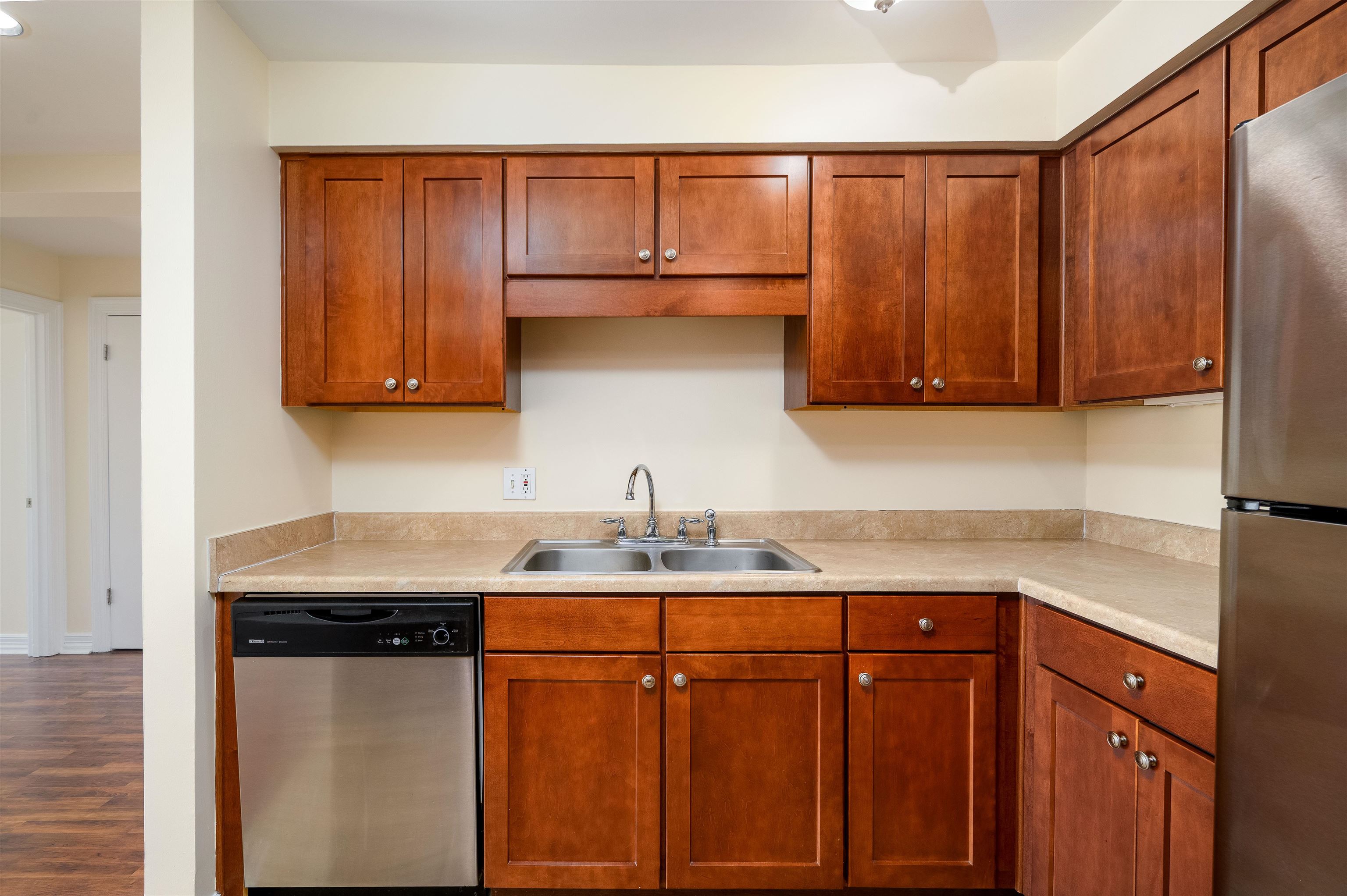 655 Riverside Drive, Unit 606A Memphis, TN 38103 - Photo 7 of 35 a kitchen with stainless steel appliances granite countertop wooden cabinets a sink and dishwasher