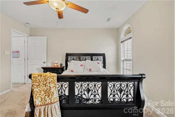 a bedroom with furniture and wooden floor