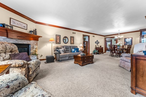 197 Mathews Road, Unit A Youngstown, OH 44512 - Photo 6 of 32 Carpeted living room featuring a fireplace, ornamental molding, and an inviting chandelier