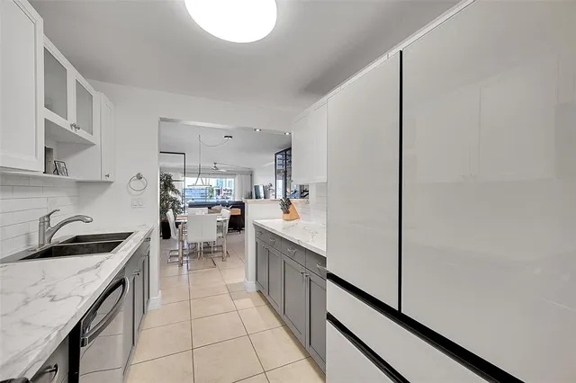 a kitchen that has a lot of cabinets in it and appliances