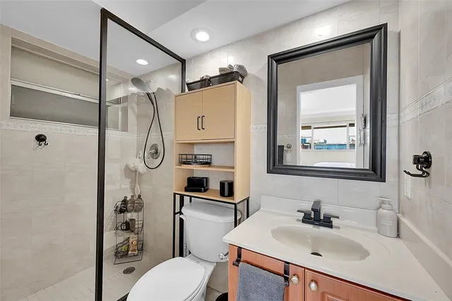 a bathroom with a sink toilet and shower