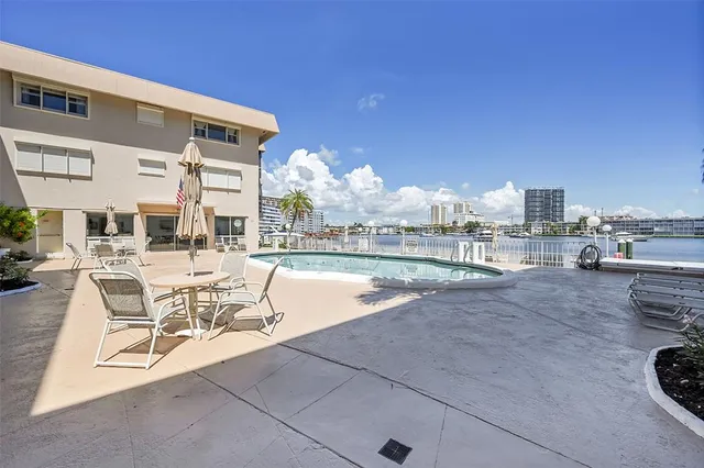 a view of a patio with swimming pool table and chairs