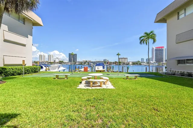 a swimming pool with outdoor seating and yard