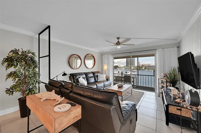 a living room with furniture a window and a flat screen tv