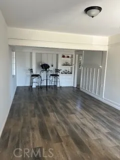 a living room with furniture and a dining table