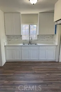 a view of a kitchen with white cabinets