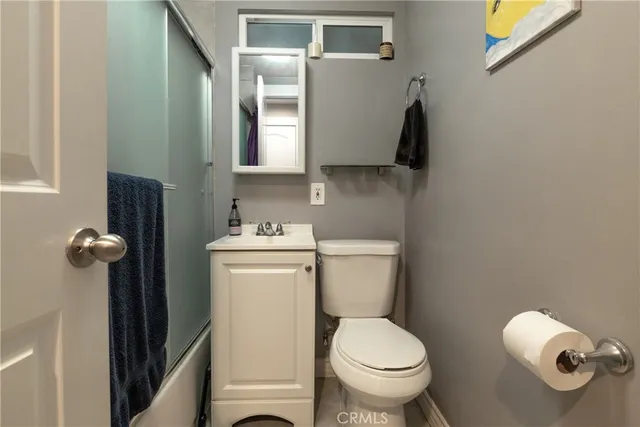 a view of a tree in the backyard of a house