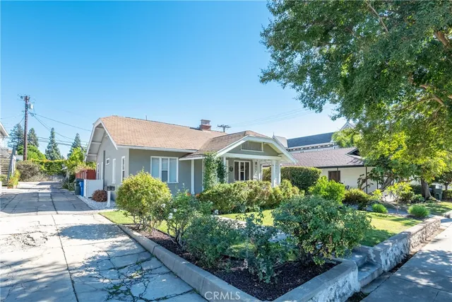 a front view of a house with a garden