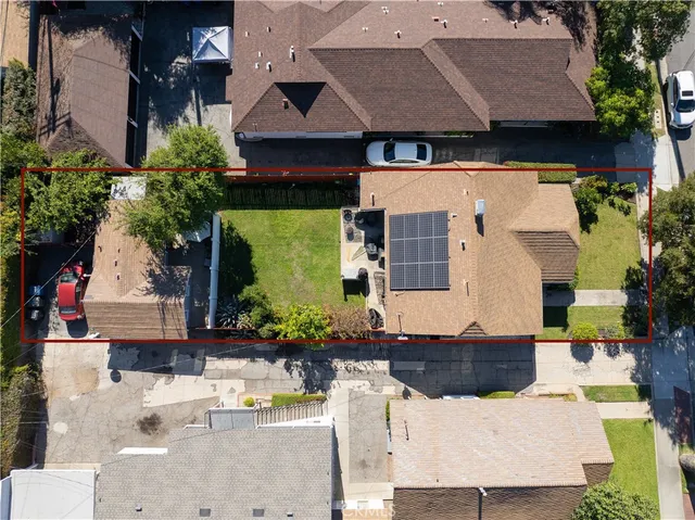 an aerial view of a house with a yard