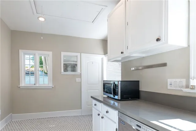 a kitchen with stainless steel appliances a microwave and sink