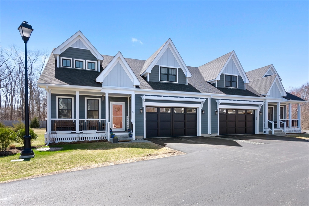 18 Primrose Lane, Unit 18 Ipswich, MA 01938 - Photo 1 of 39 a front view of a house with a yard and garage