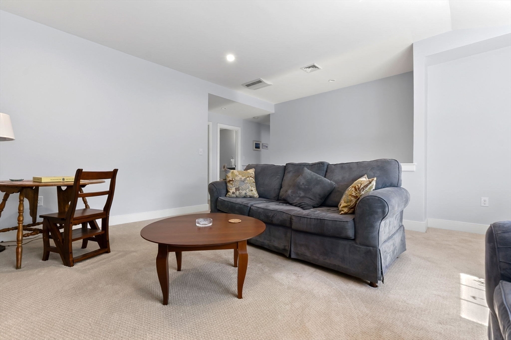 18 Primrose Lane, Unit 18 Ipswich, MA 01938 - Photo 23 of 39 a living room with furniture and a rug