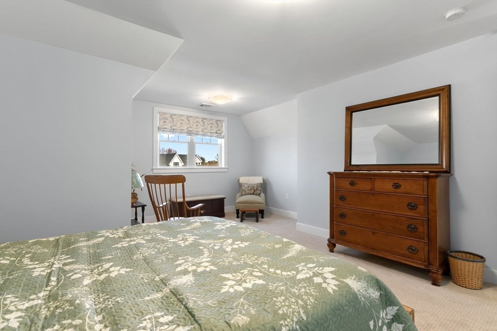 18 Primrose Lane, Unit 18 Ipswich, MA 01938 - Photo 24 of 39 a bedroom with a bed and a window