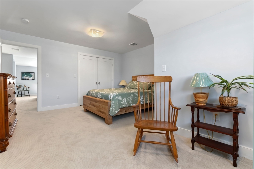18 Primrose Lane, Unit 18 Ipswich, MA 01938 - Photo 25 of 39 a bedroom with furniture and a bed