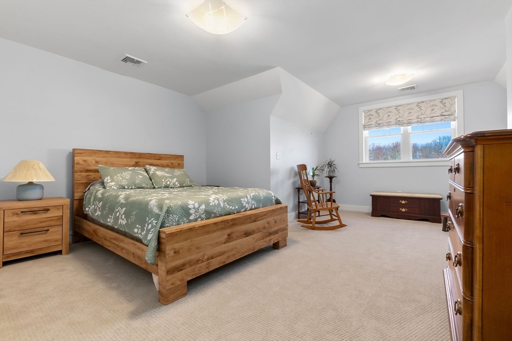 18 Primrose Lane, Unit 18 Ipswich, MA 01938 - Photo 26 of 39 a bedroom with a bed and a night stand
