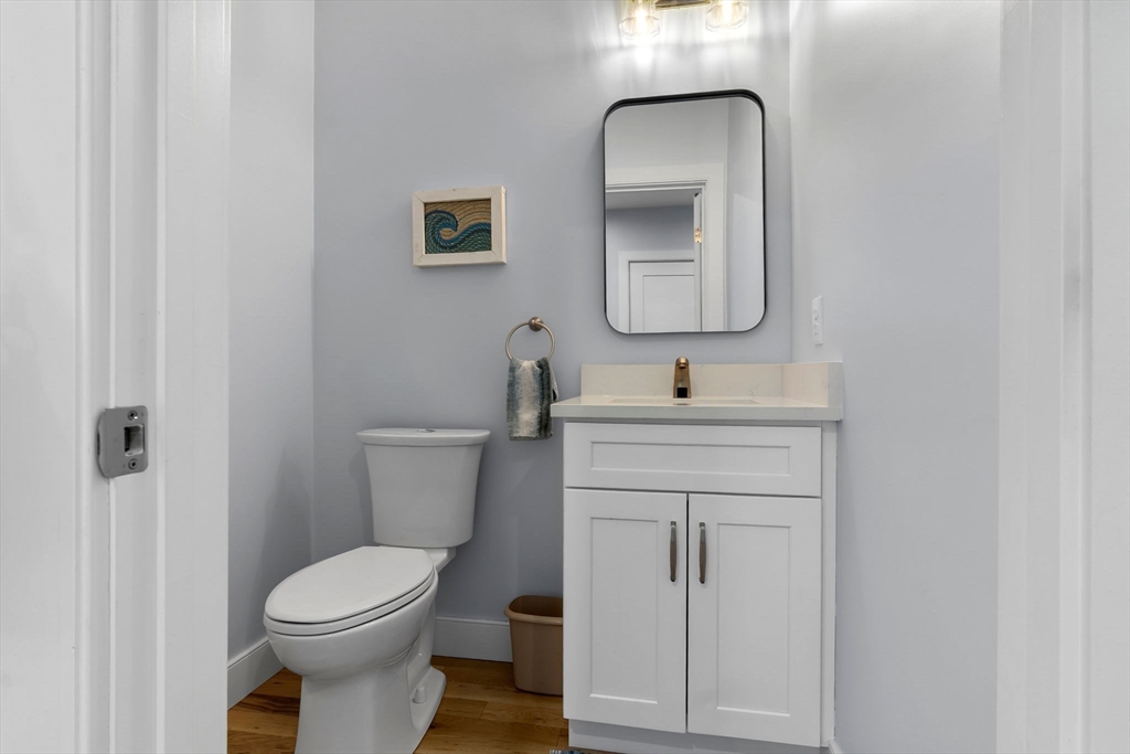 18 Primrose Lane, Unit 18 Ipswich, MA 01938 - Photo 35 of 39 a bathroom with a toilet sink vanity and mirror