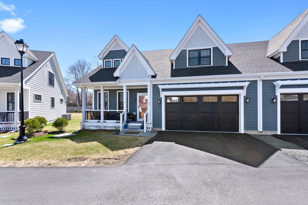 18 Primrose Lane, Unit 18 Ipswich, MA 01938 - Photo 38 of 39 a front view of a house with a yard and porch
