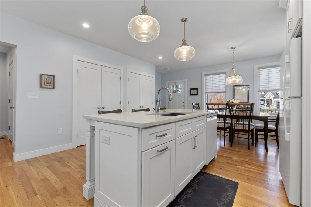 18 Primrose Lane, Unit 18 Ipswich, MA 01938 - Photo 7 of 39 an open kitchen with a table and chairs