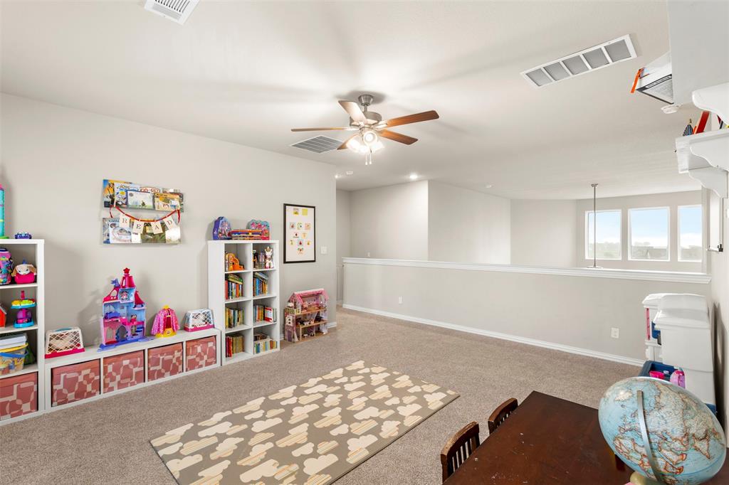107 Yampa Court Rhome, TX 76078 - Photo 20 of 30 Spacious loft area featuring light-toned walls, neutral carpeting, and multiple windows