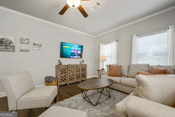 a living room with furniture and a flat screen tv