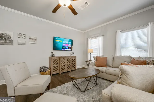 a living room with furniture and a flat screen tv