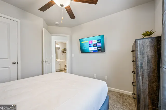 a bedroom with a large bed a chandelier and closet