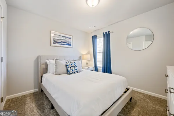 a bedroom with a bed and a painting