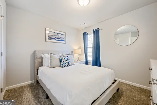 a bedroom with a bed and a painting