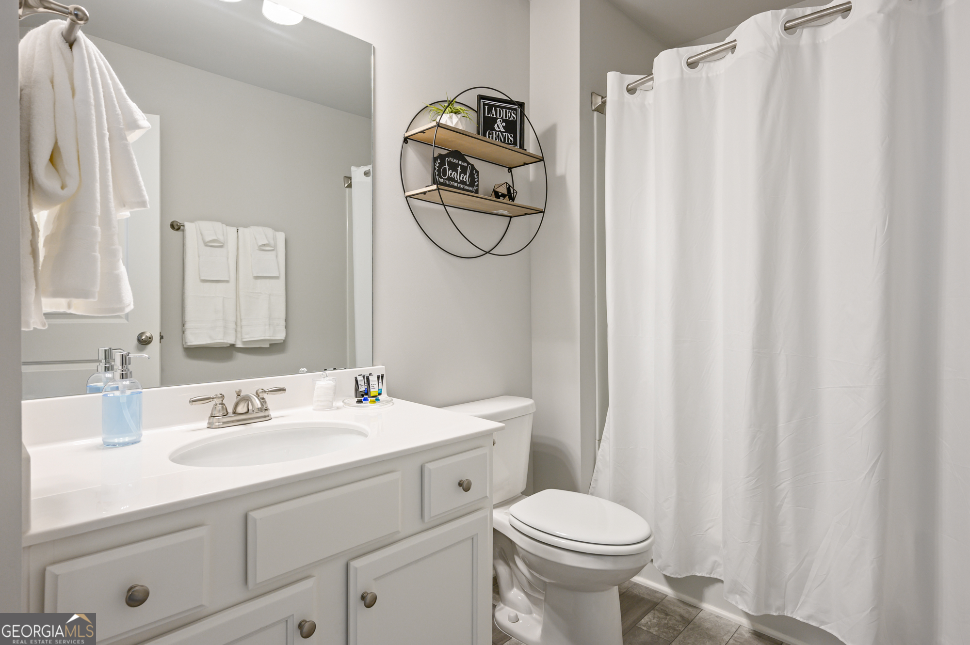 2059 Pinnacle Walk Norcross, GA 30071 - Photo 20 of 27 a bathroom with a sink a toilet and a mirror
