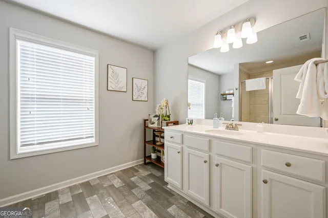 a bathroom with a sink vanity and a mirror