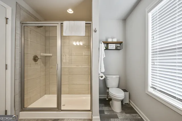 a bathroom with a toilet and a shower