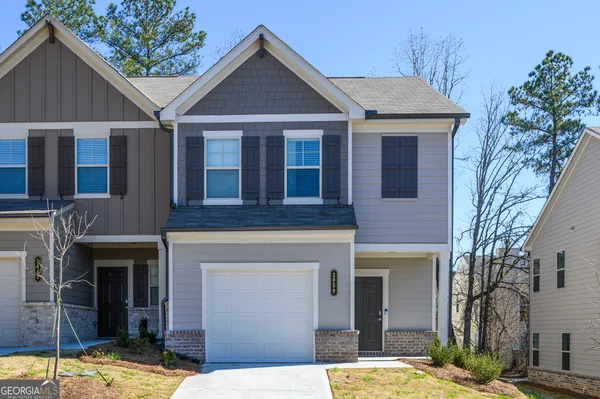 a front view of a house with a yard