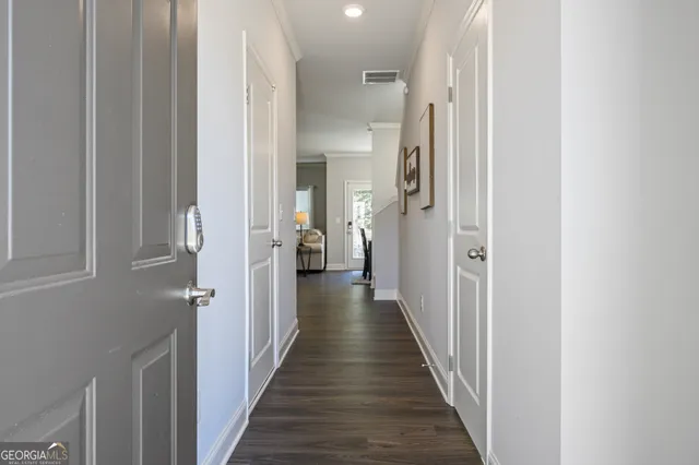a view of a hallway with a wooden floor
