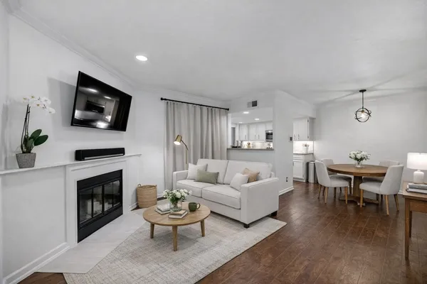 a living room with furniture a fireplace and a flat screen tv