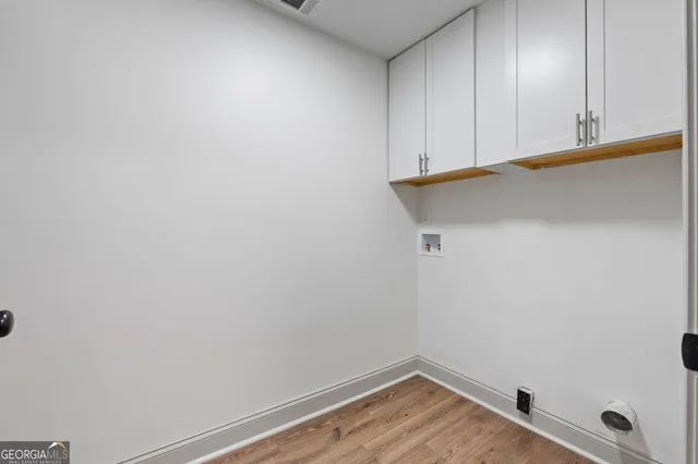 a view of a room with wooden floor