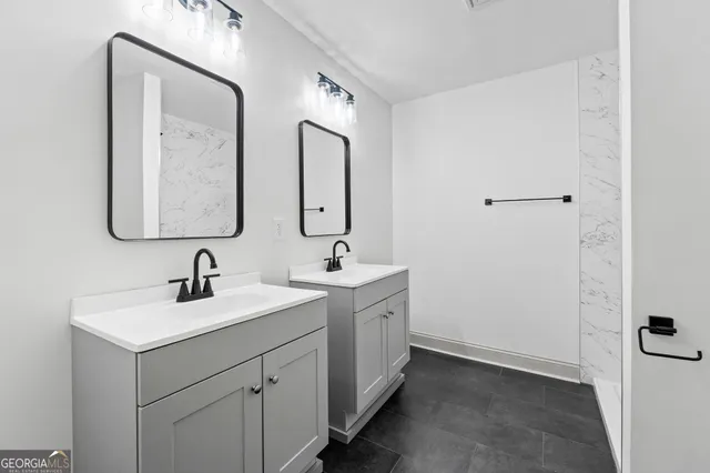 a bathroom with 2 sink and a mirror