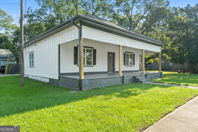 a backyard of a house with seating and garden