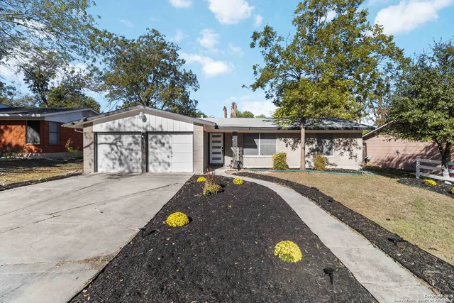 a front view of a house with yard and patio