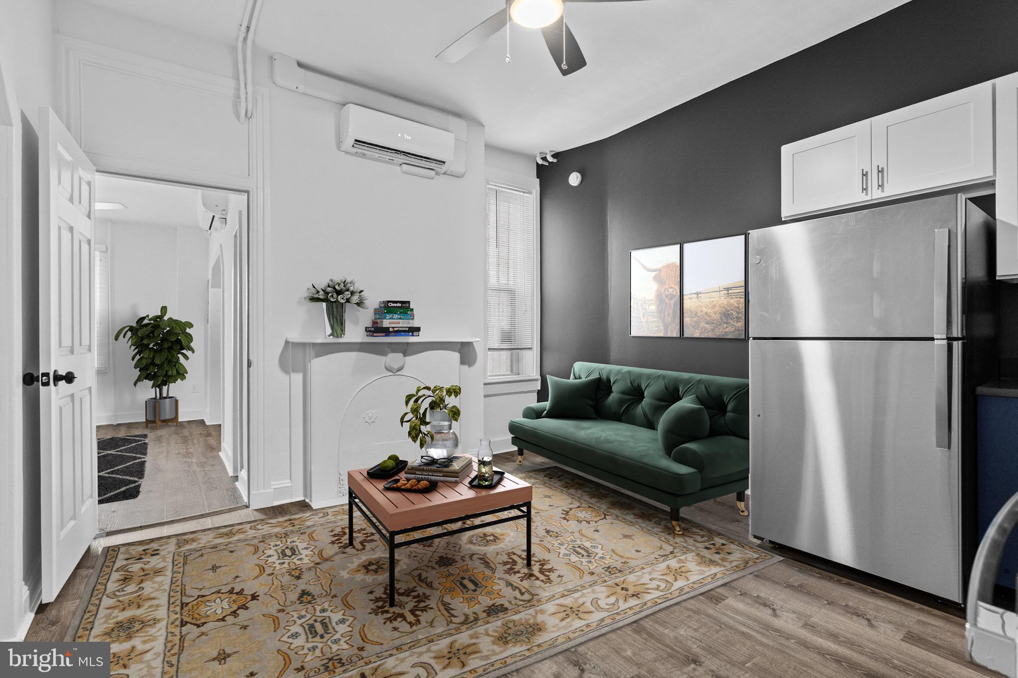 1308 West Lexington Street, Unit 2R Baltimore, MD 21223 - Photo 4 of 12 a living room with furniture and a potted plant